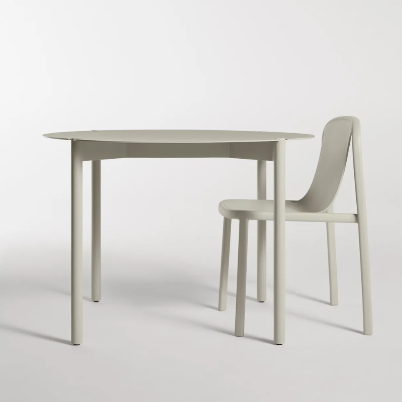 The Round Comeuppance Dining Table from Blu Dot in putty in an office.