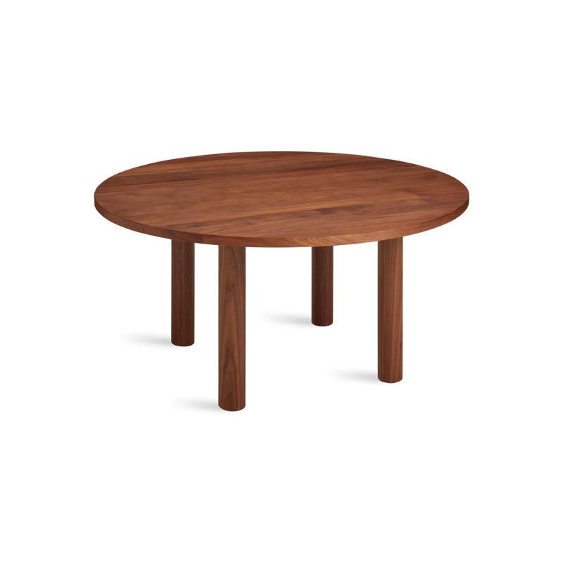 The Round Good Times Dining Table from Blu Dot in walnut from an angle.
