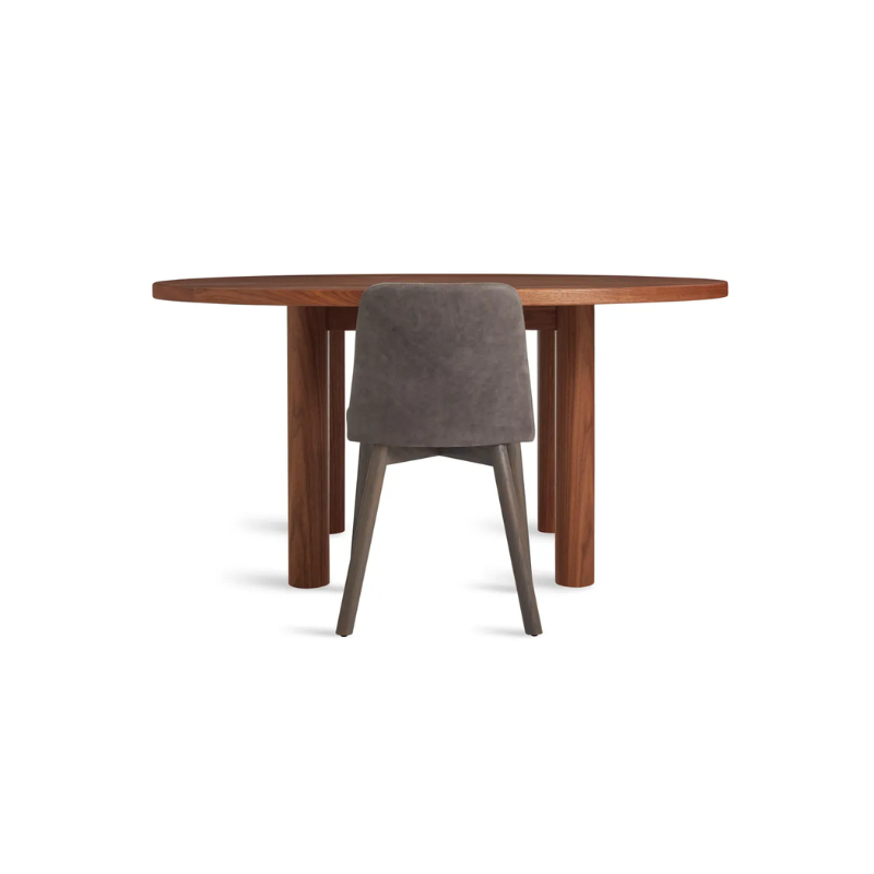 The Round Good Times Dining Table from Blu Dot in walnut in a living room.