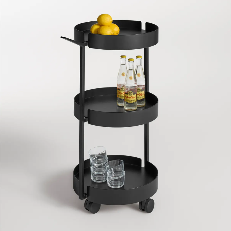 The Scoots McGee Cart from Blu Dot in black used as a bar cart in a studio.