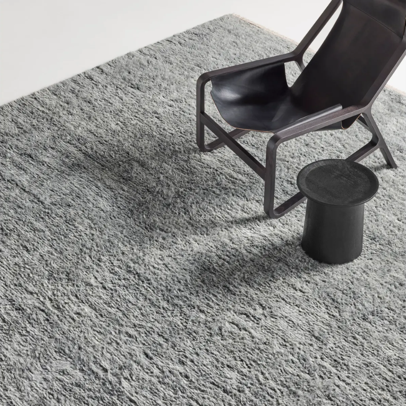 The Shadow Play Rug from Blu Dot in Charcoal wool in a lounge.