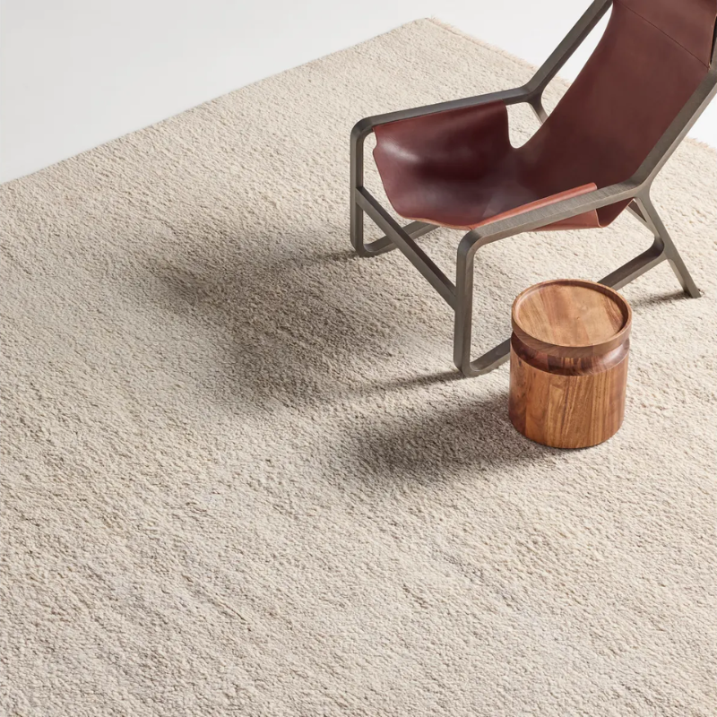 The Shadow Play Rug from Blu Dot in Sand wool in a family room.