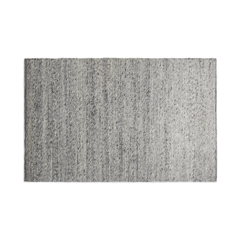 The five by eight foot Sinder Rug from Blu Dot in Grey handwoven wool.