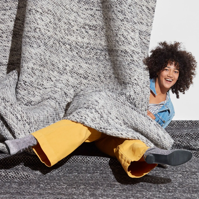 The Sinder Rug from Blu Dot in Charcoal and Grey handwoven wool in a lifestyle. all-groups