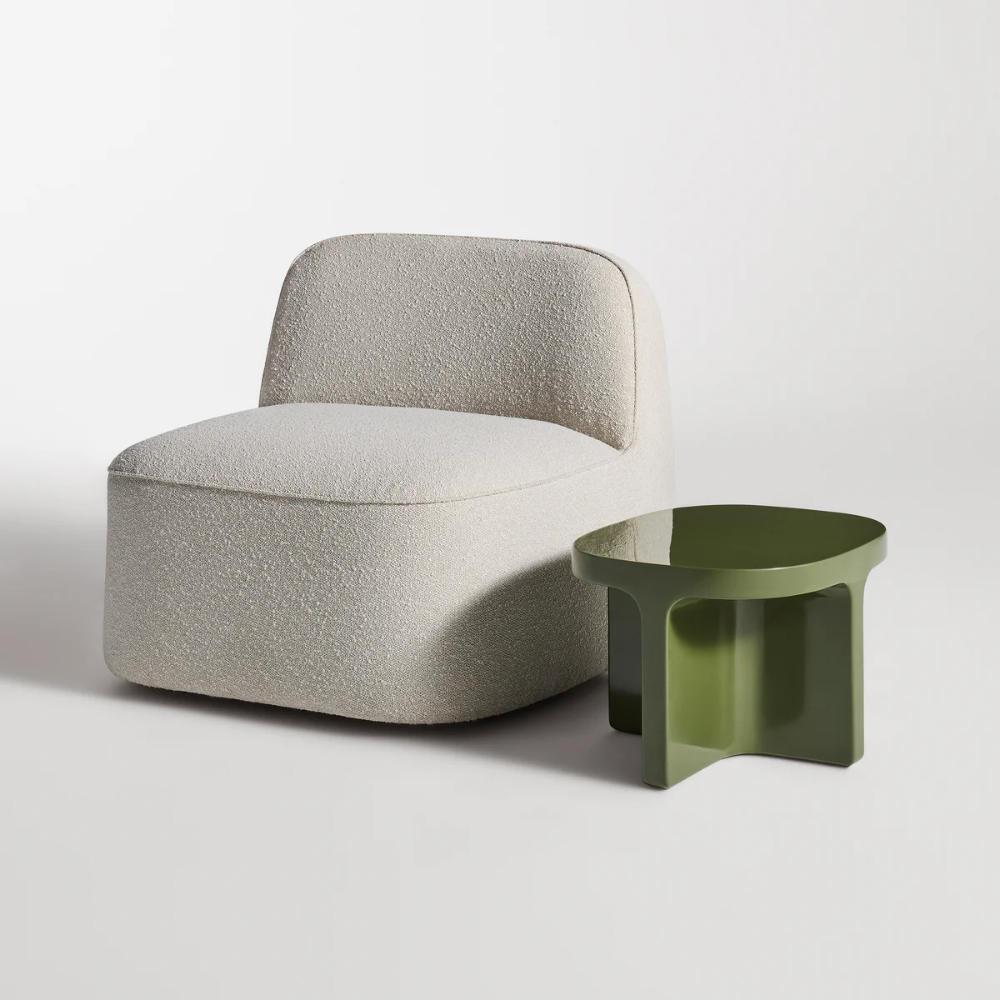 The olive Small Talk Short Side Table from Bludot with looksee swivel lounge chair in studio.