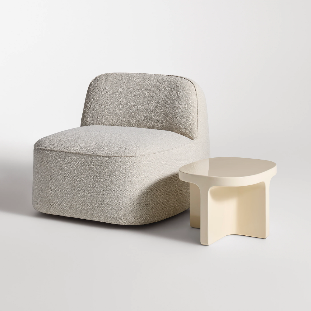 The ivory Small Talk Short Side Table from Bludot with looksee swivel lounge chair in studio.