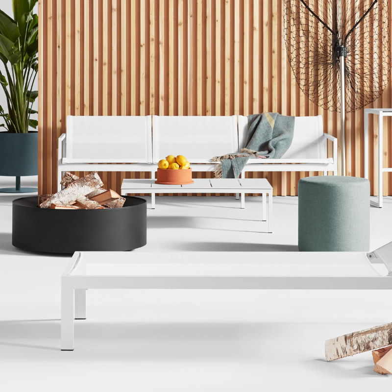 The Smokey Fire Pit from Blu Dot in an outdoor space.