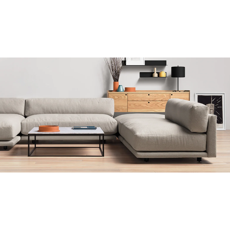 The Sunday Chaise by Blu Dot in a living room.