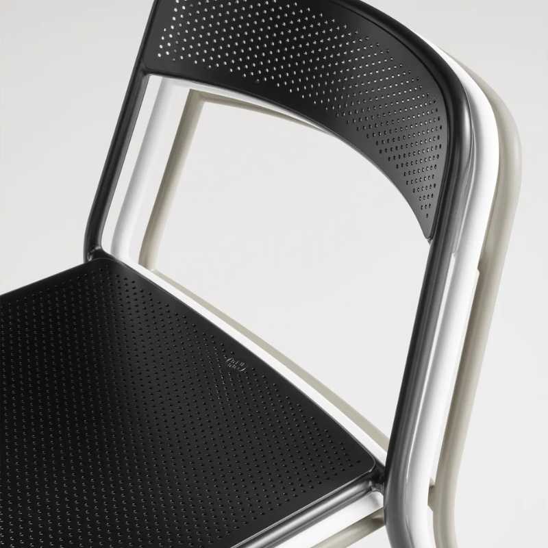 A set of three Trim Chairs from Blu Dot stacked in a close up.