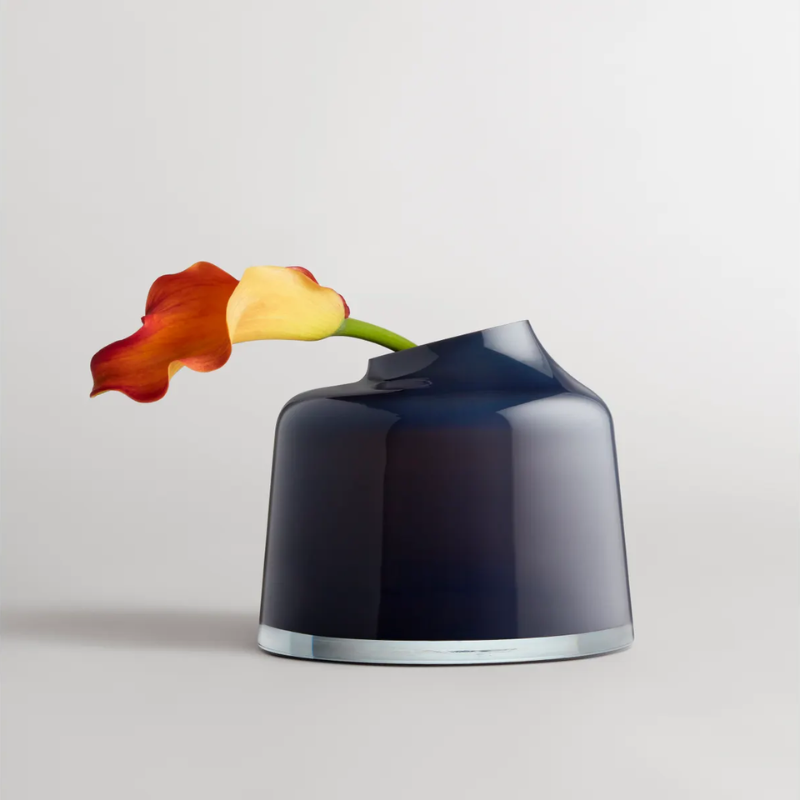 The Variant Large Glass Vase from Blu Dot in a living room with a flower.