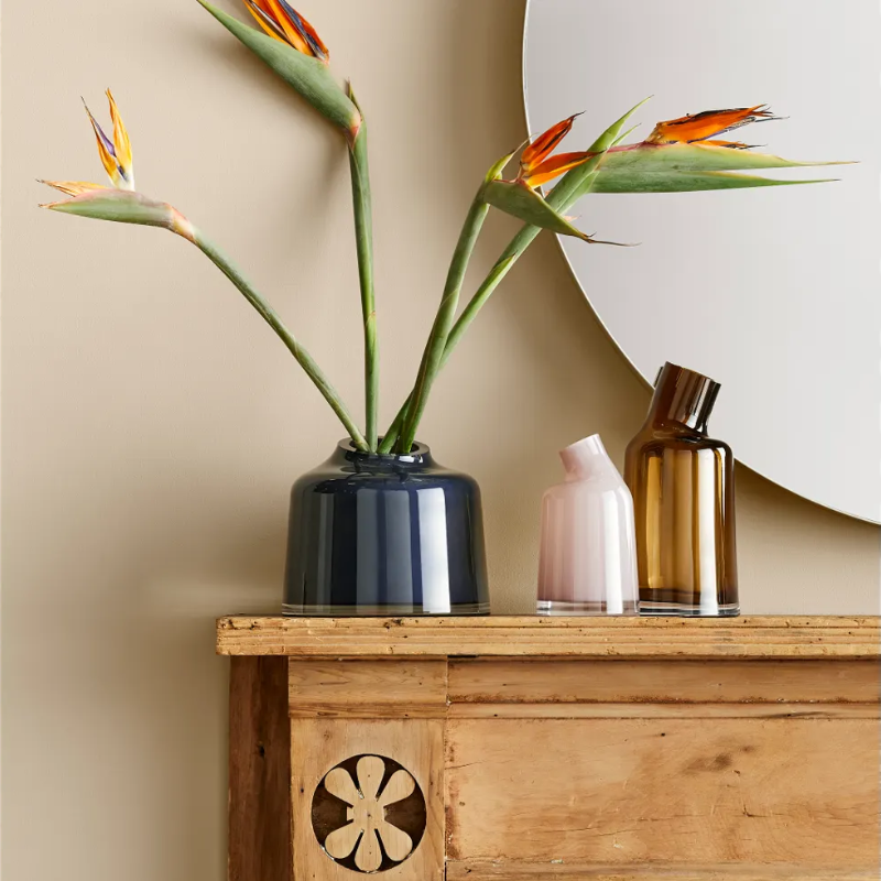 The Variant Large Glass Vase from Blu Dot in a primary bedroom.