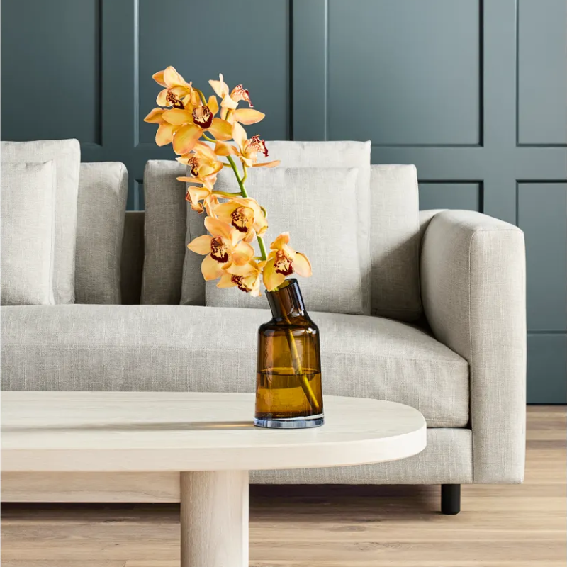 The Variant Medium Glass Vase from Blu Dot in a living room.