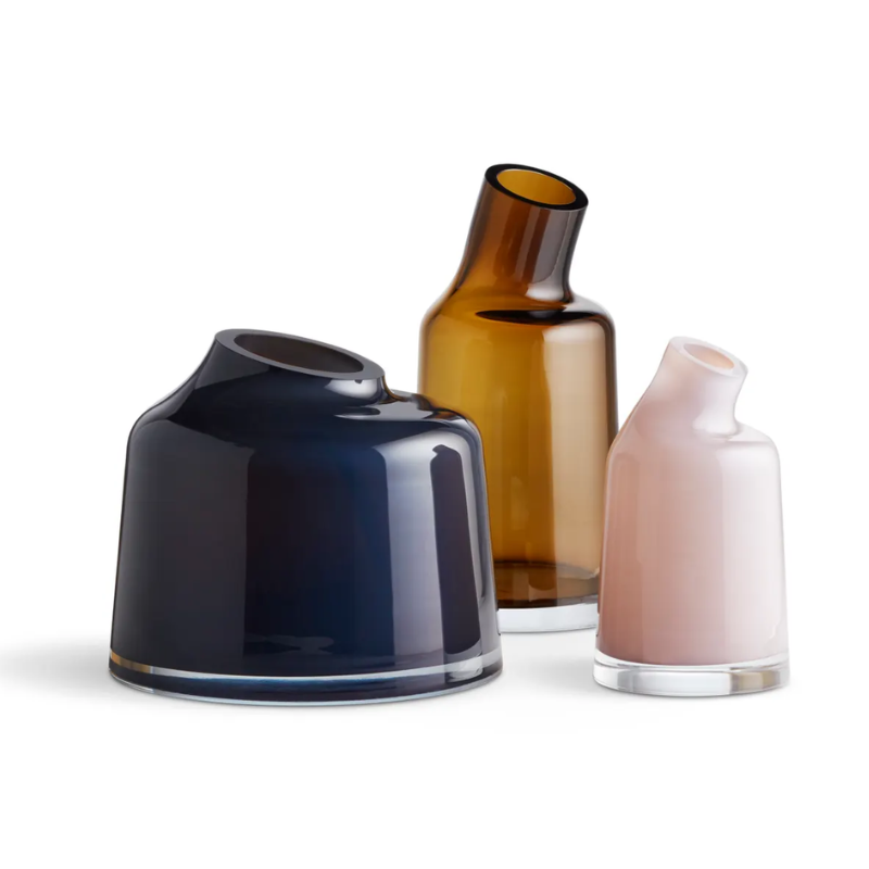 The Variant Small Glass Vase from Blu Dot in a lounge with other vases.