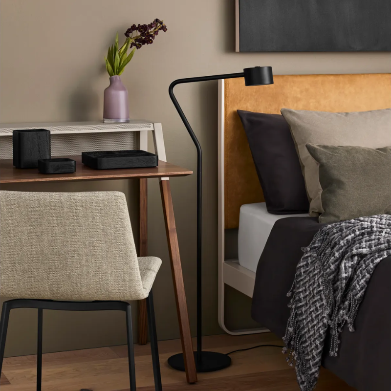 The Variant Small Glass Vase from Blu Dot in a primary bedroom.