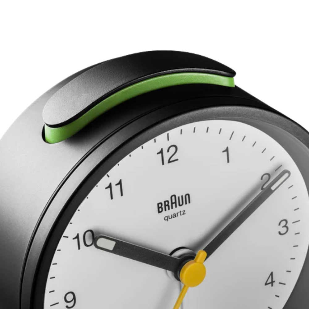 The black and white BC12 Round Alarm Clock by Braun from a top close-up.