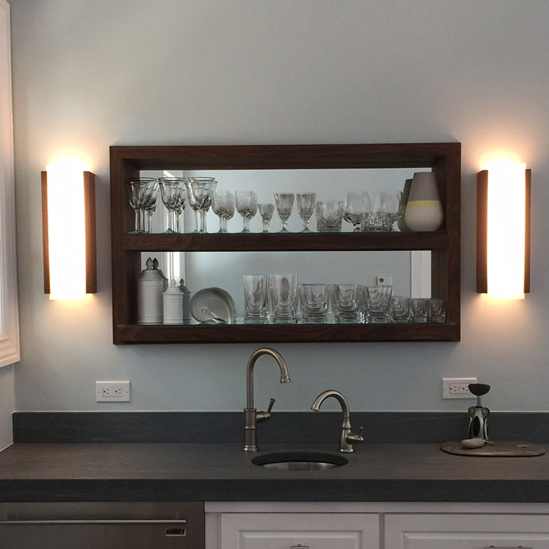 The Capio Sconce from Cerno in walnut in a kitchen.