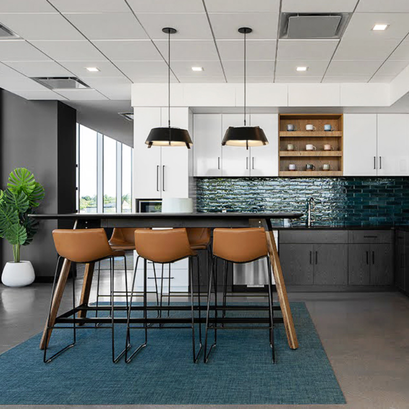 The Large Casia Pendant from Cerno with the walnut wood body in a kitchen and dining area.