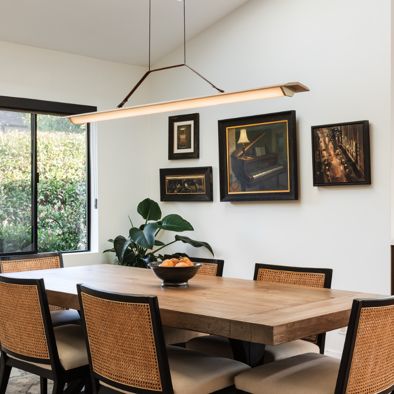 The Penna Linear Pendant from Cerno in a dining room.