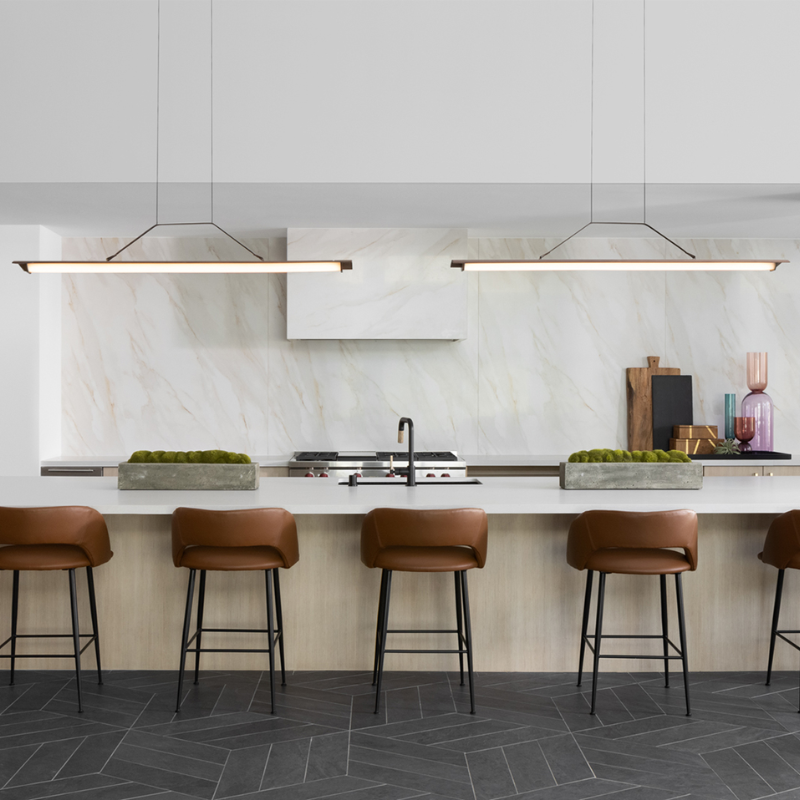 The Penna Linear Pendant from Cerno above a kitchen bar.