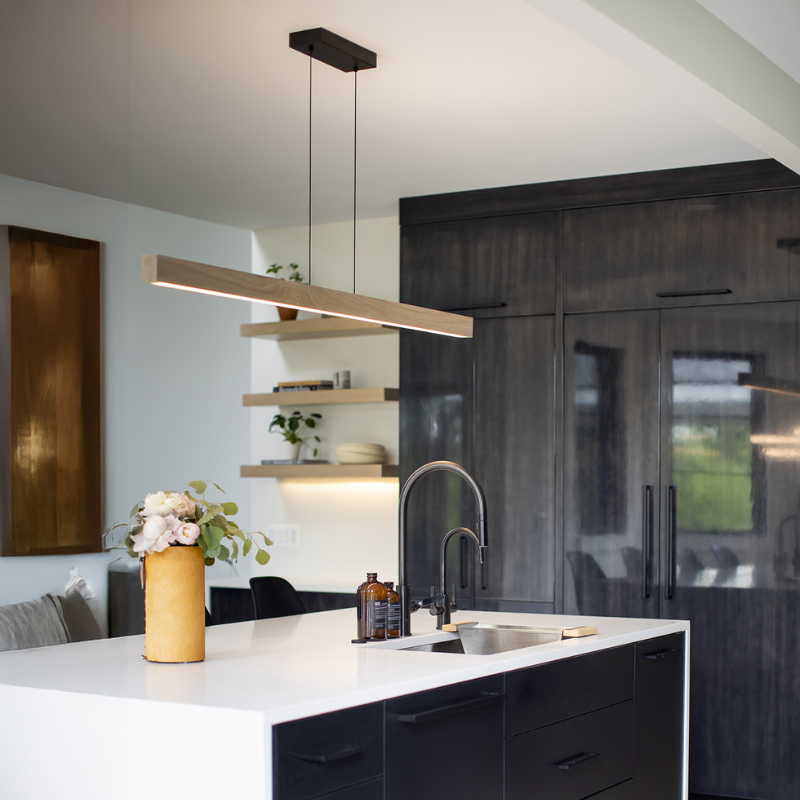 The Una LED Linear Suspension – Uplight and Downlight from Cerno in white washed oak in a kitchen.