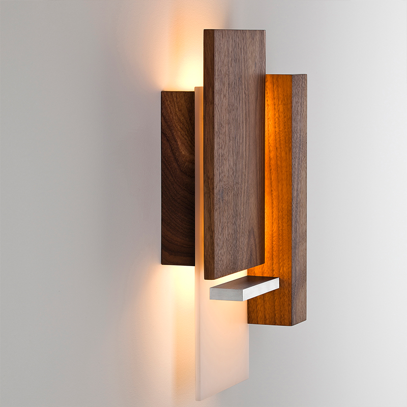 The Vesper Wall Sconce from Cerno in oiled walnut in a home office.
