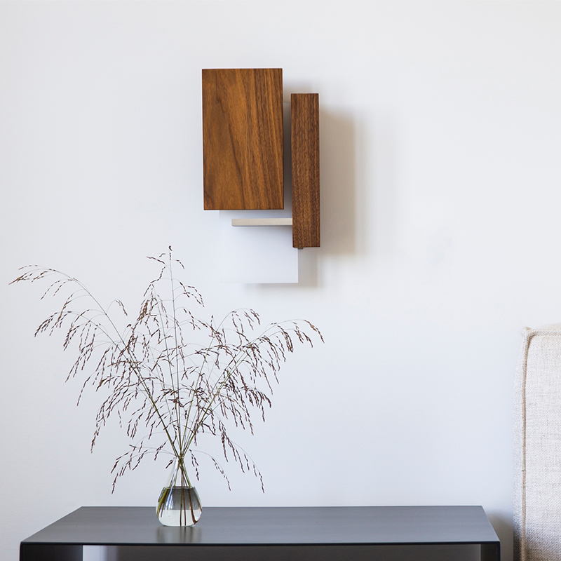 The Vesper Wall Sconce from Cerno in oiled walnut in a kids room.