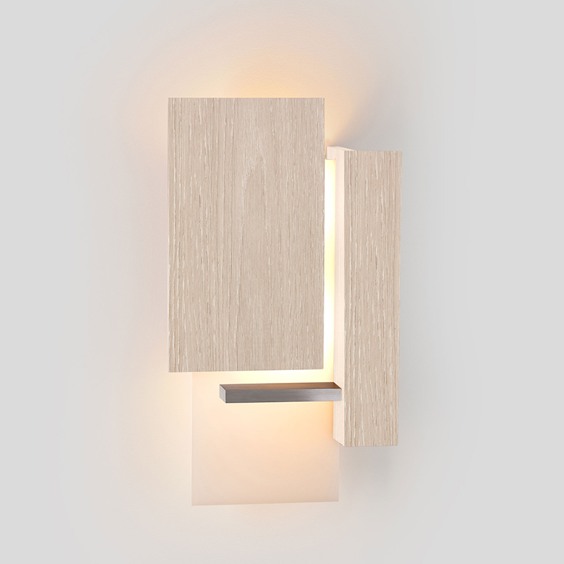 The Vesper Wall Sconce from Cerno in white washed oak in a hallway.