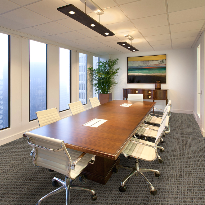 The Vix Linear Pendant from Cerno in walnut in a business space.