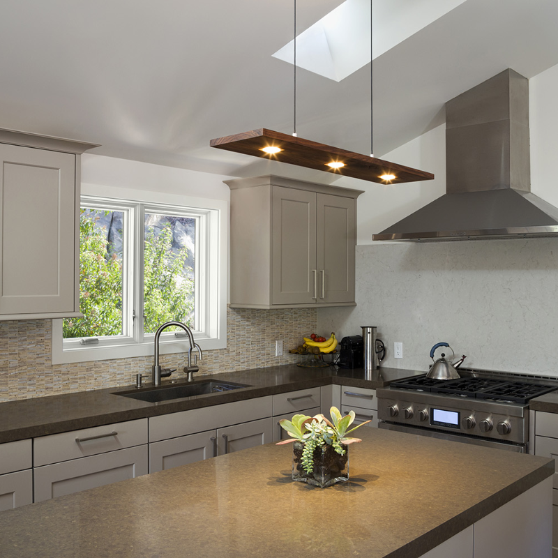 The Vix Linear Pendant from Cerno in walnut in a kitchen.