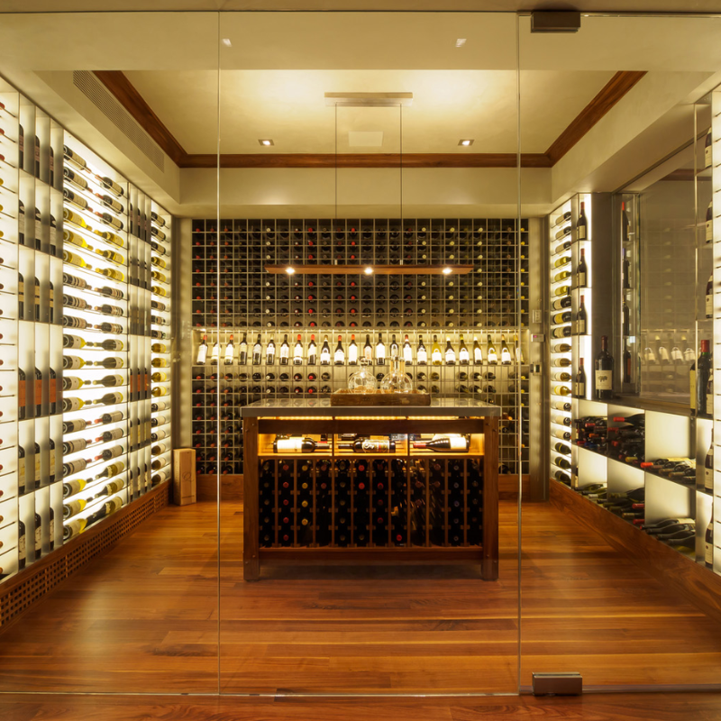 The Vix Linear Pendant from Cerno in walnut in a wine storage area.