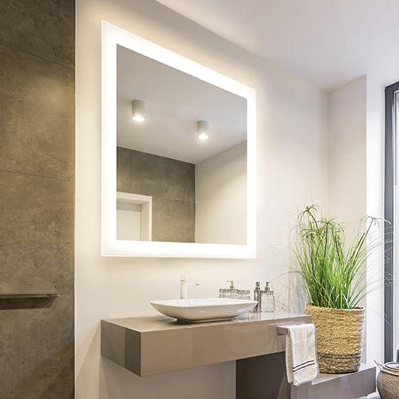 The Silhouette Lighted Mirror from Electric Mirror in a primary bathroom.