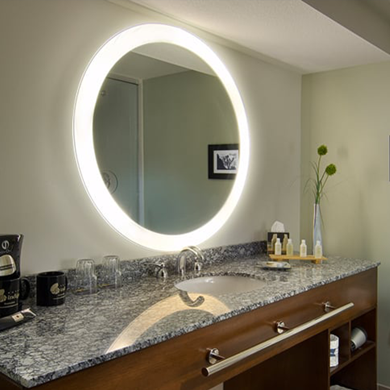 The Trinity Lighted Mirror from Electric Mirror in a hotel dressing area.