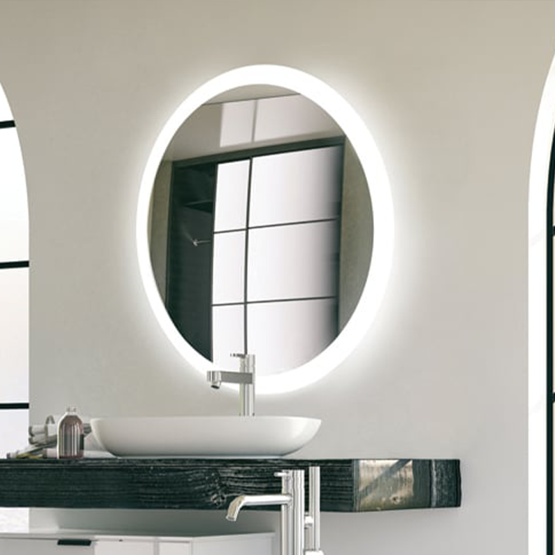 The Trinity Lighted Mirror from Electric Mirror in an office bathroom.