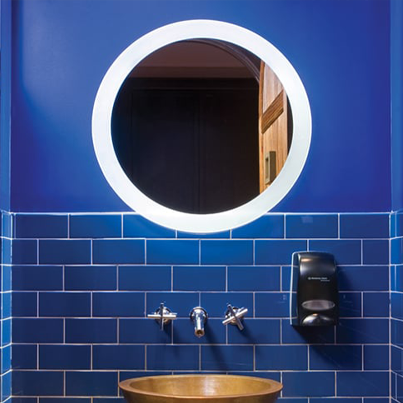 The Trinity Lighted Mirror from Electric Mirror in a primary bathroom.