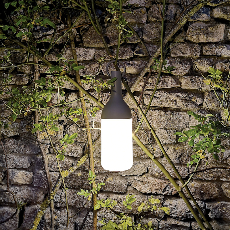 The ELO Baby Portable Table Lamp by Bina Baitel for DesignerBox in a garden.