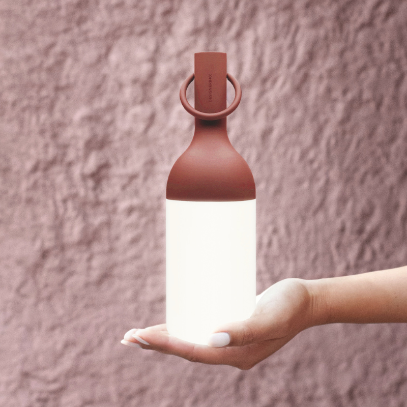 The ELO Baby Portable Table Lamp by Bina Baitel for DesignerBox handheld.