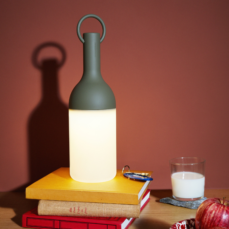 The ELO Baby Portable Table Lamp by Bina Baitel for DesignerBox in an office.