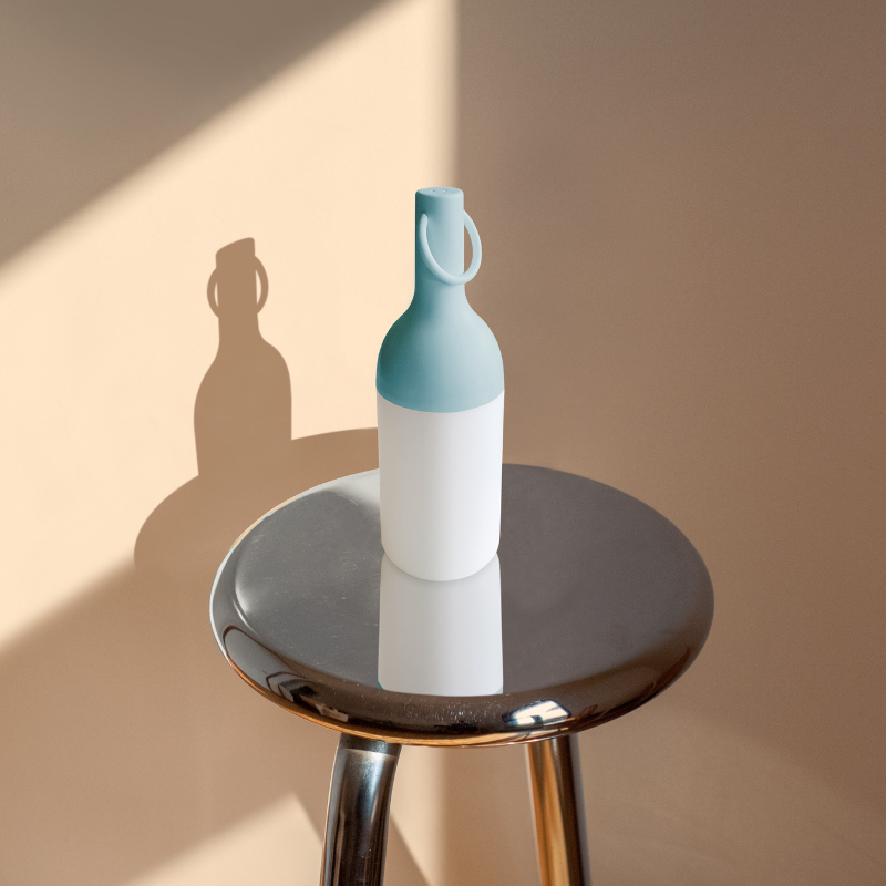 The ELO Baby Portable Table Lamp by Bina Baitel for DesignerBox on a stool.