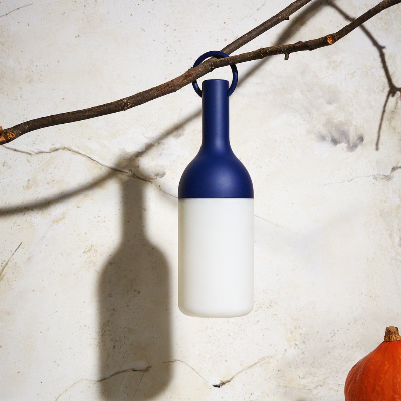 The ELO Portable Table Lamp by Bina Baitel for DesignerBox in a garden.