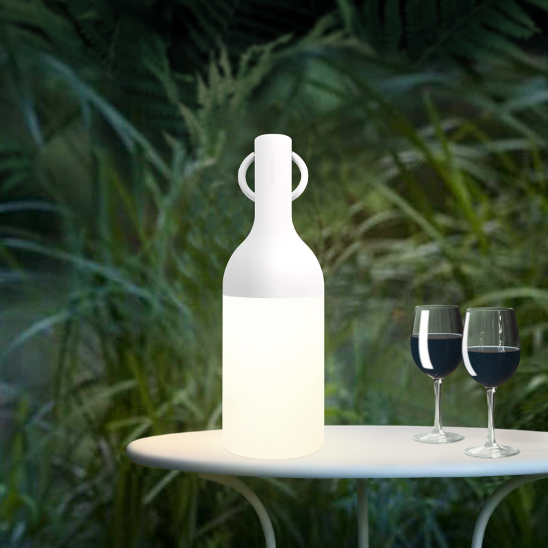The ELO Portable Table Lamp by Bina Baitel for DesignerBox in an outdoor dining setting.