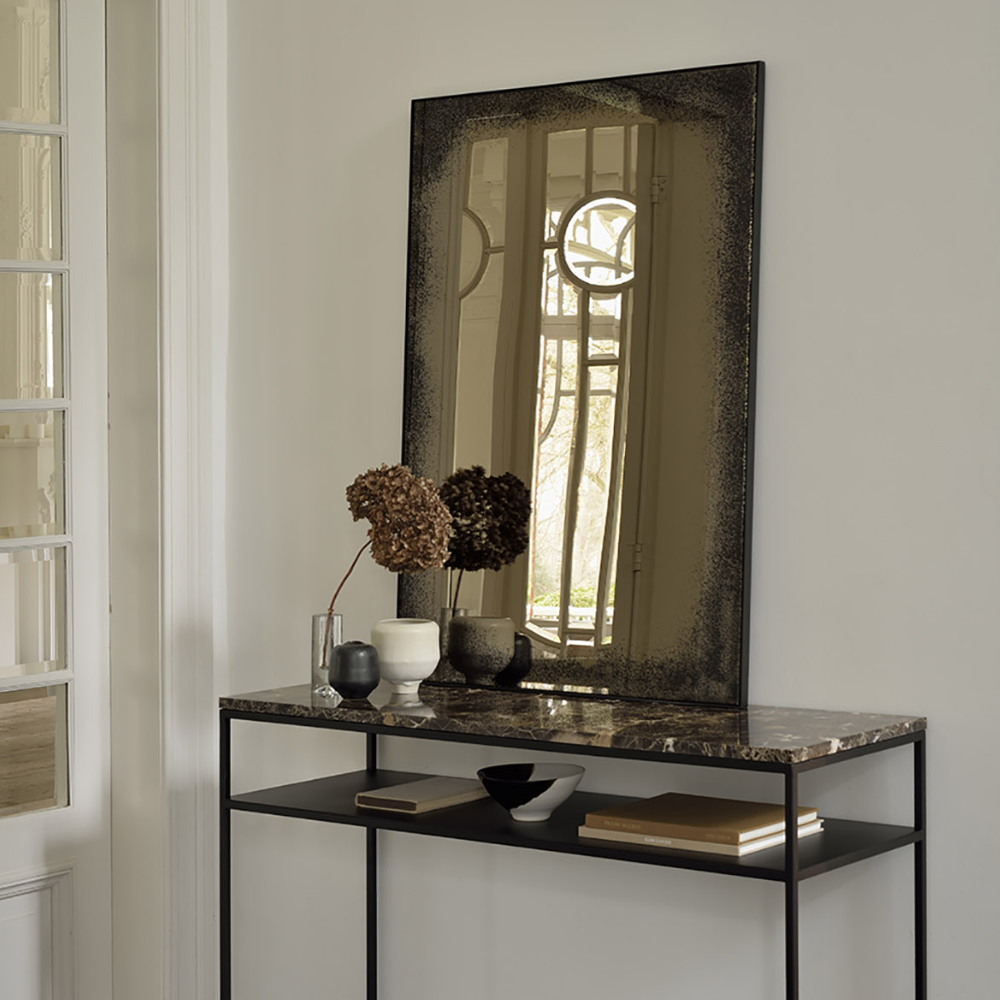The Aged Wall Mirror Rectangle, bronze copper 41.5 inches from Ethnicraft in a dressing room.