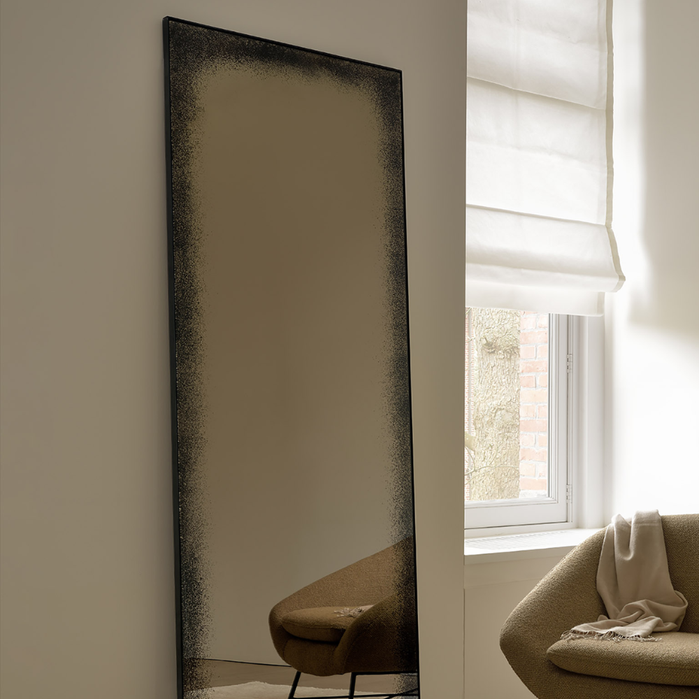 The Aged Wall Mirror Rectangle, bronze copper 78.5 inches from Ethnicraft in a living room.