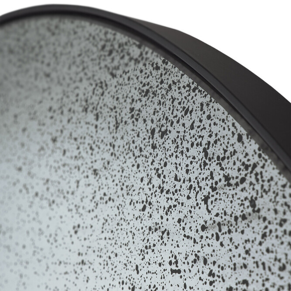 The Aged Wall Mirror Round clear from Ethnicraft with a close-up from the side.