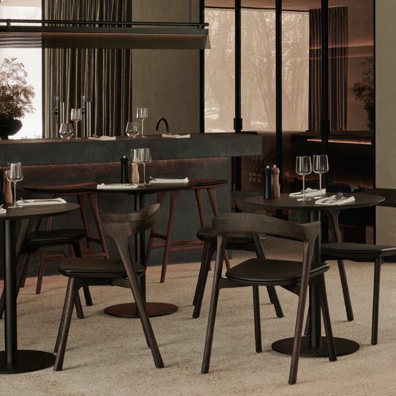 The Blend Dining Table from Ethnicraft in brown oak in a dining room.