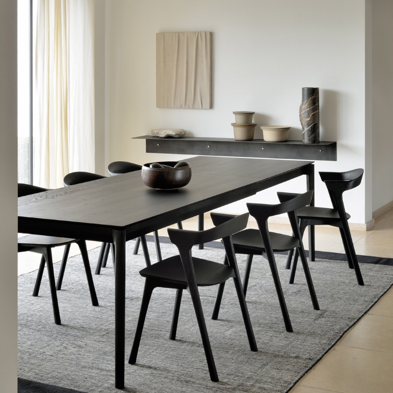 The Bok Extendable Dining Table from Ethnicraft in black oak in a dining space.
