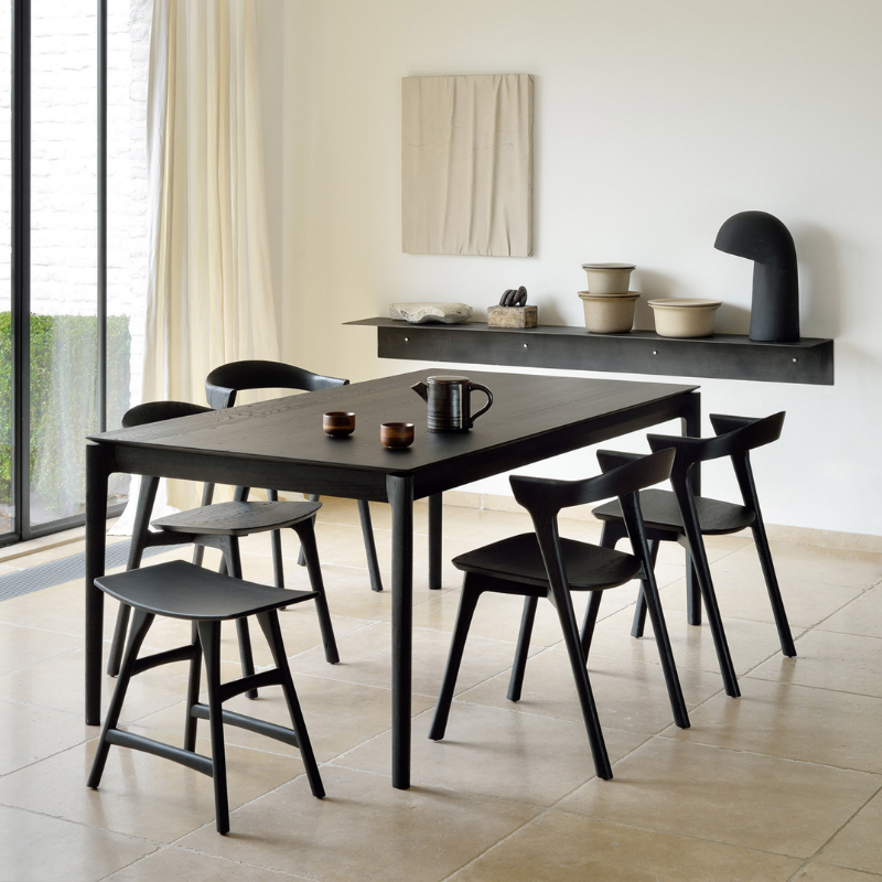 The Bok Extendable Dining Table from Ethnicraft in black oak in a living room.