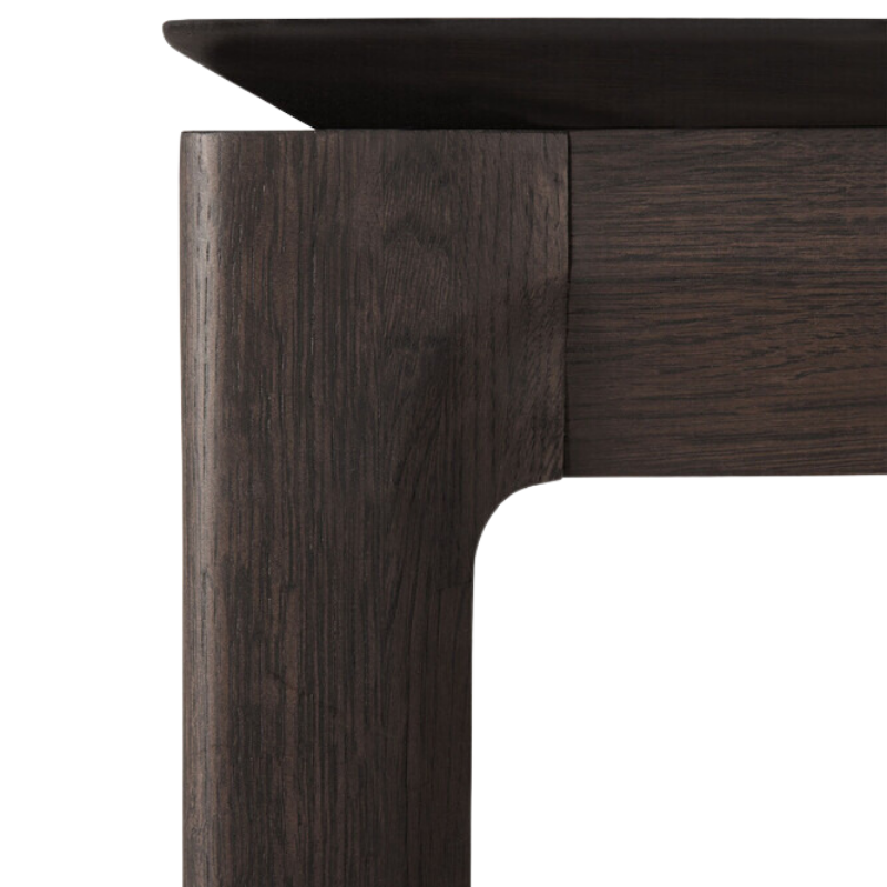 The Bok Extendable Dining Table from Ethnicraft in brown oak close up.