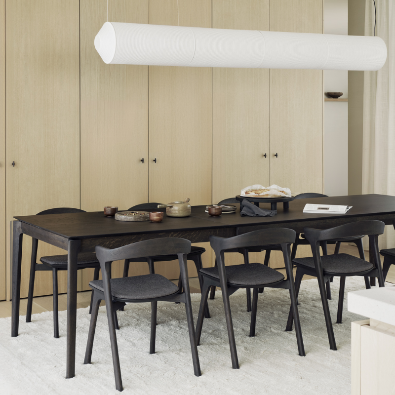 The Bok Extendable Dining Table from Ethnicraft in brown oak in a kitchen and dining setting.