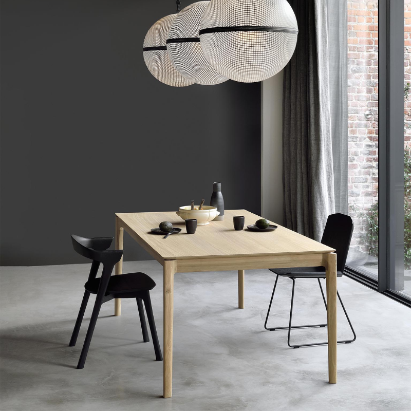 The Bok Extendable Dining Table from Ethnicraft in oak in a dining space.