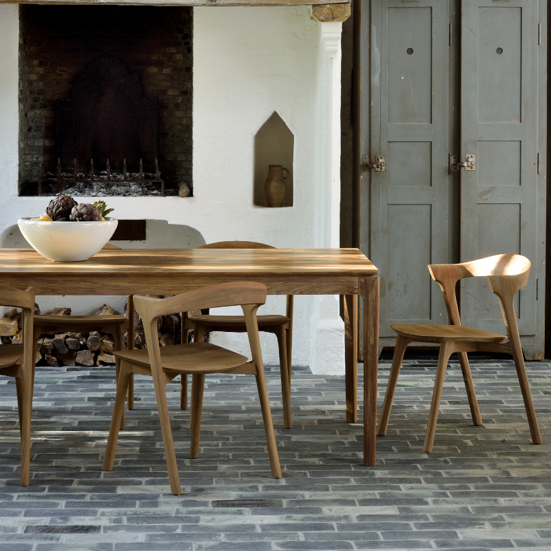 The Bok Extendable Dining Table from Ethnicraft in teak in a dining room.